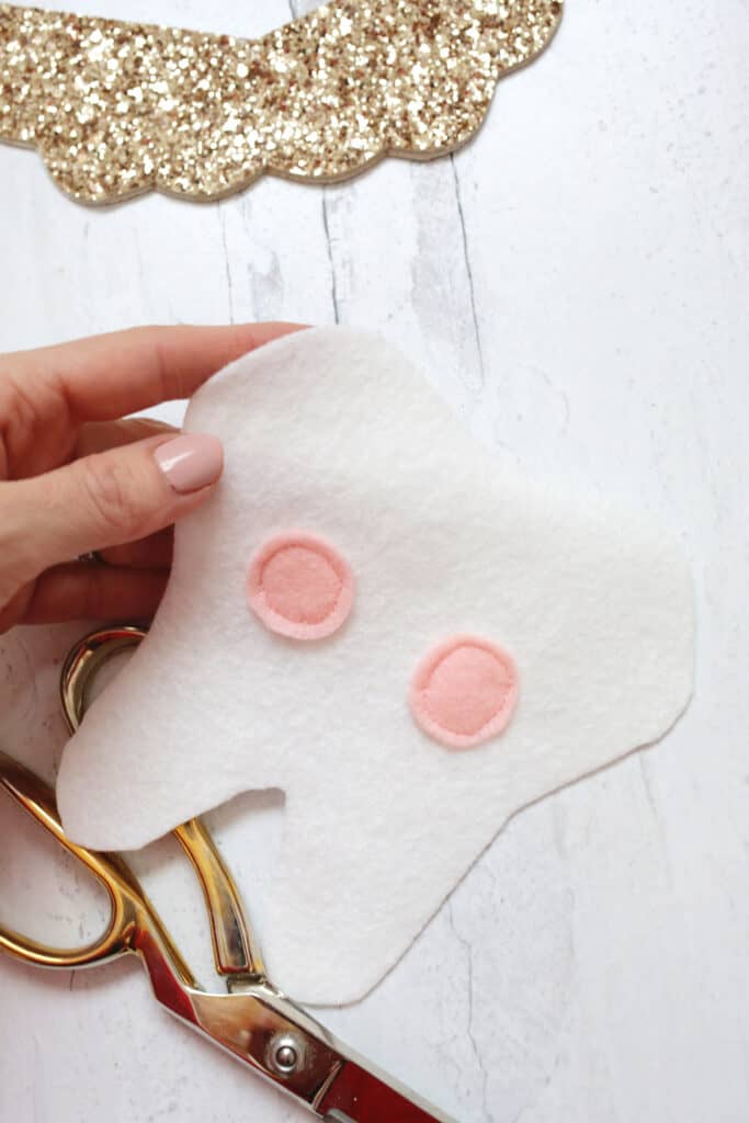Pink cheeks sewn onto tooth cutout