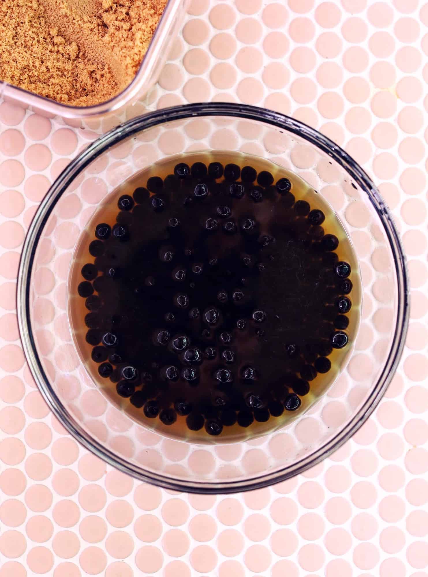 glass mixing bowl of boba pearls in water
